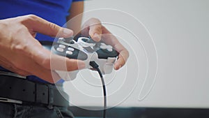 Man concept playing gamepad hands video console on tv. Hand hold new joystick playing video console on tv. Gamer play