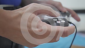 Man concept playing gamepad hands video console on tv. Hand hold new joystick playing video console on tv. Gamer play