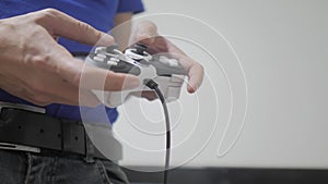 Man concept playing gamepad hands video console on tv. Hand hold new joystick playing video console on tv. Gamer play