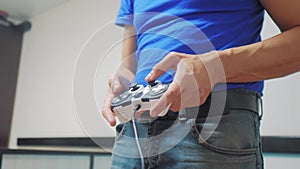 Man concept playing gamepad hands video lifestyle console on tv. Hand hold new joystick playing video console on tv