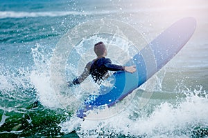 Man concur sea waves hold surf board water splash