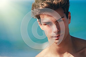 Man confident gaze, handsome face model. Hair style. Blue background