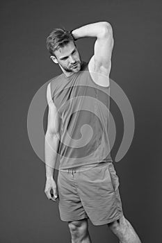 Man confident in his antiperspirant. Guy checks dry armpit satisfied with healthy skin. Prevent, reduce perspiration. No photo