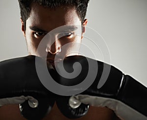 Man, confident and portrait with boxing gloves in studio for self defense, mma and combat. Male person, fighter and