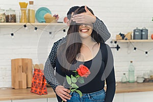 The man congratulates the girl in the kitchen, romantic exiting moment, relatioship concept