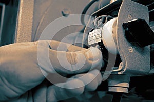 Man connecting cables wiring a switch on an industrial machine