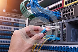 Man connecting fiber network cables