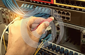 Man connecting fiber network cables