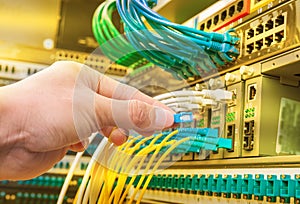 Man connecting fiber network cables