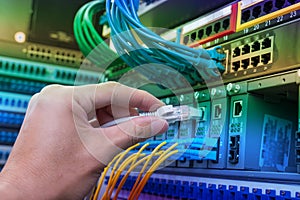 Man connecting fiber network cables