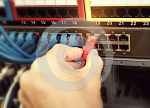 Man connecting fiber network cables