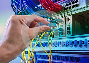 Man connecting fiber network cables