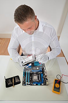Man Connecting Harddisk With The Motherboard