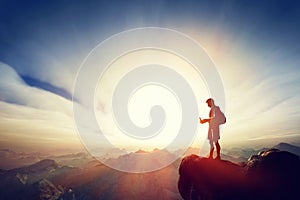 Man connecting with his smartphone on top of the mountain. Communication