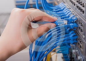 Man connecting network cable