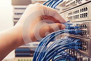 Man connecting network cables