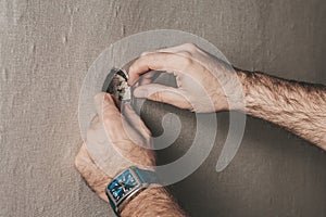 Man connects an electrical light switch to the wall - electrical work