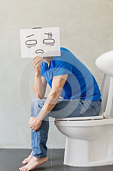 Man with constipation on toilet