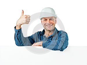 Man in a construction helmet shows gesture OK