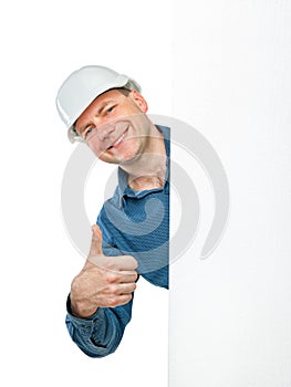 man in a construction helmet shows gesture OK