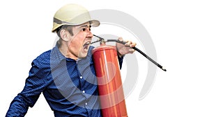 A man in a construction helmet on a white isolated background holds a fire extinguisher in his hands and shouts. The foreman.