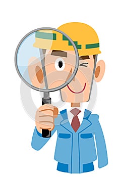 Man in construction site in blue work wear checks with magnifying glass