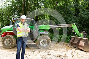 man on a construction site in front of an excavator