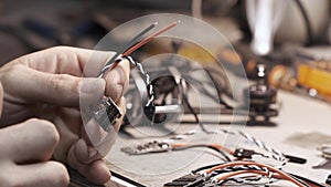 Man constructs a FPV copter in a workshop.