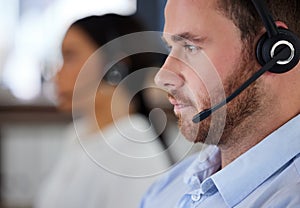 Man, consultant and headset in call center office, working and customer support or telemarketing service in coworking