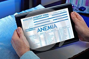 Man consulting on internet your medical record with anemia diagnosis photo
