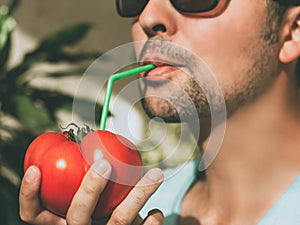 Man consume nutrition directly from tomato fruit