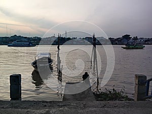 A man is contemplating on the banks of the musi river Palembang.
