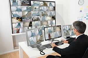 Man in control room looking at cctv footage