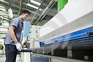 Man controlling hydraulic press machine