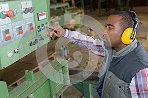 Man controlling industrial machine