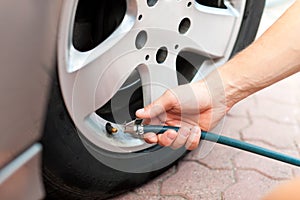 Man is controlling the tire pressure of his car