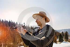 Man controls the flying drones in snowy forest winter. Adventurous winter holiday