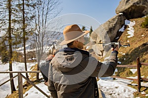 Man controls the flying drones in snowy forest winter. Adventurous winter holiday