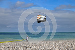 A man controls a kite on the shores of the Atlantic Ocean