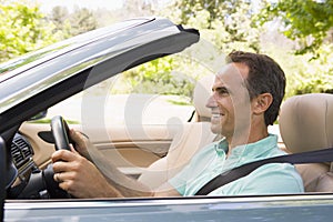 Man in convertible car smiling