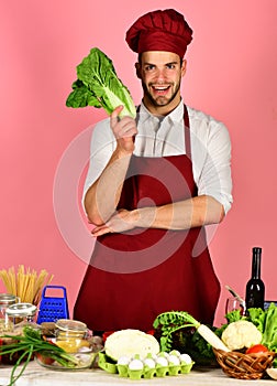 Man in cook hat and apron with salad.