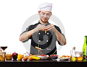A large young guy, the chef, breaks the egg into a black plate.