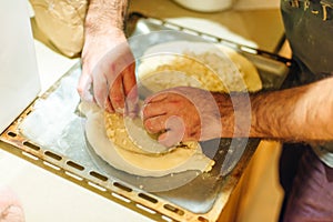 Man cook Traditional Georgian dish khachapuri ajarian. National Georgian pastries with cheese and raw eggs