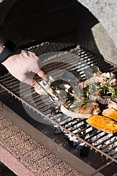 Man cooking bbq steaks on grill outdoors.