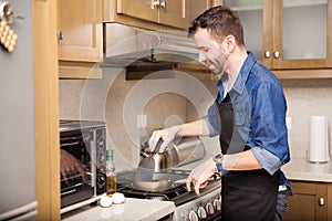 Man cooking breakfast at home