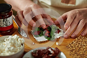 Man cooking bruschetta, only hands in frame.