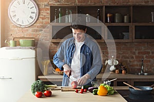 Man preparing delicious and healthy food in the home kitchen