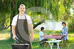 Man cooking delicious vegetables on barbecue grill outdoors