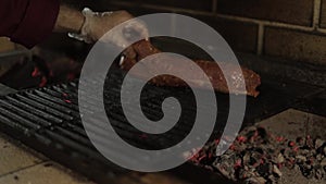 Man cooking dinner. Beef steak on grill outdoors on backyard. Raw steak. BBQ