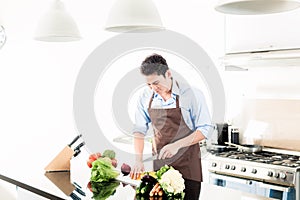 Man cooking food in minimalist kitchen